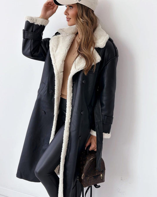 Woman wearing the black double-breasted teddy coat with cream shearling lapels, front view