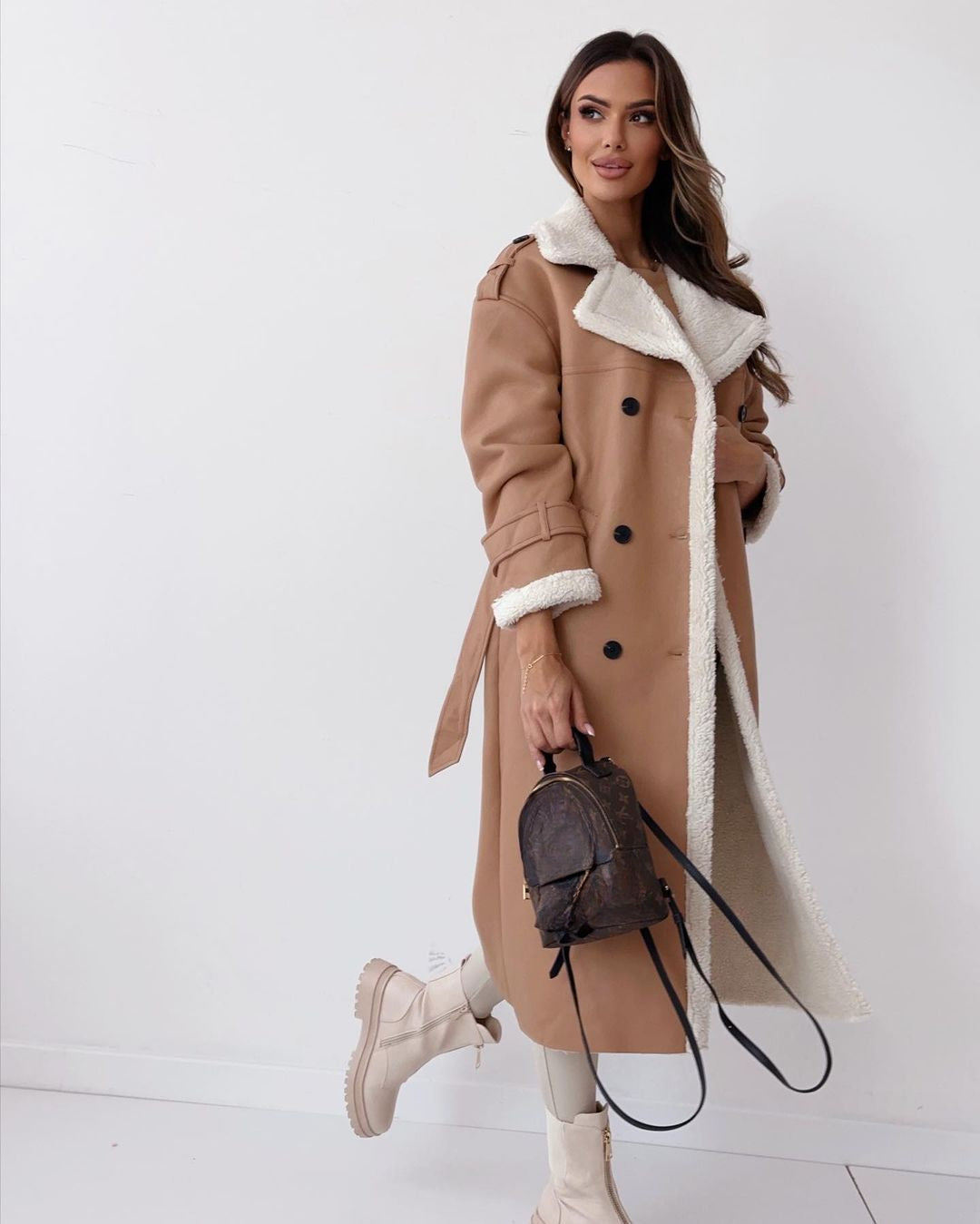Close view of the shearling collar and double-breasted buttons on the khaki teddy coat