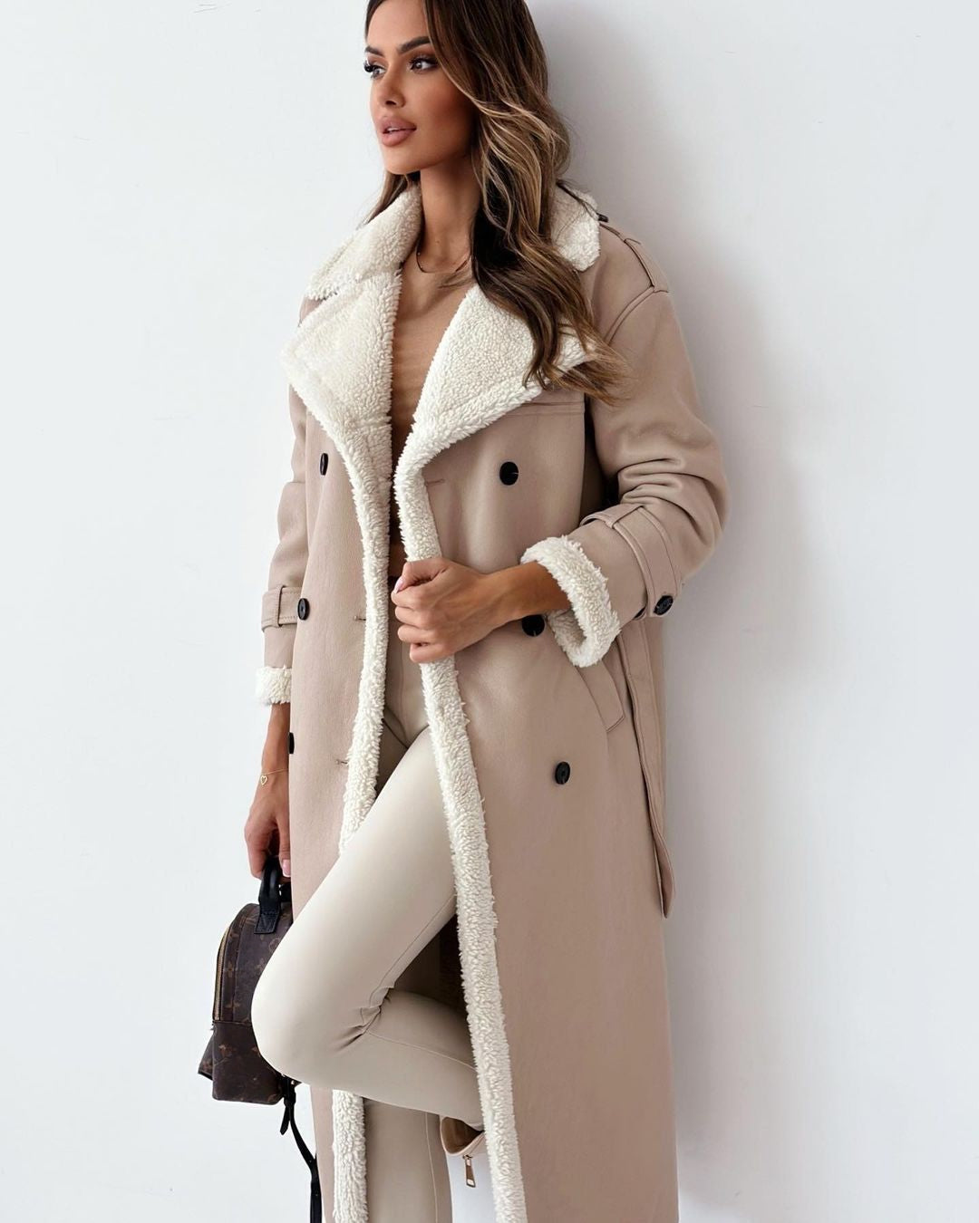 Side view of the khaki double-breasted teddy coat showing the belted waist