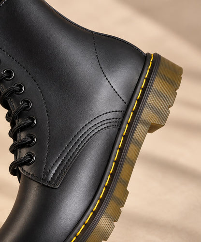 Close-up of the lacing and stitching on the black lace-up boot
