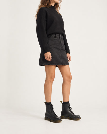 Model wearing black unisex lace-up boots in vegan leather