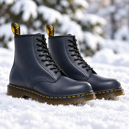 Navy blue vegan leather lace-up boots in the snow